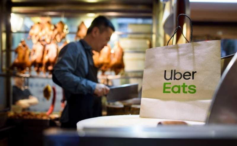 An Uber Eats delivery bag waits on the counter of a Chinese duck restaurant for it’s driver to pickup.
