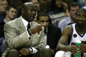 Michael Jordan in suit sitting on the bench